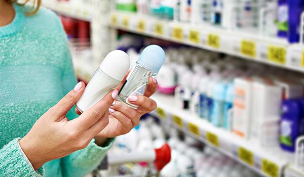 A person selecting between two different bottled products.