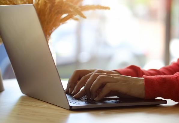 Hands typing on a keyboard.