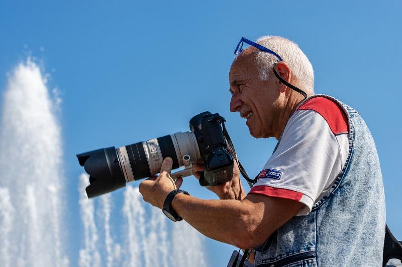 A man with a professional Canon camera.