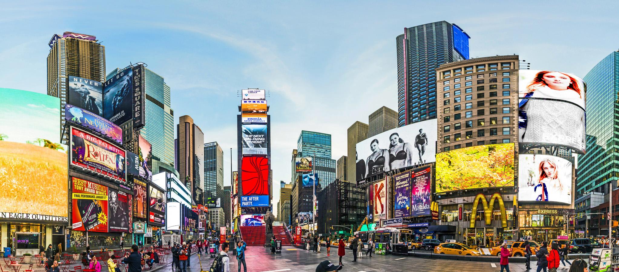 people at Times Square in early morning light