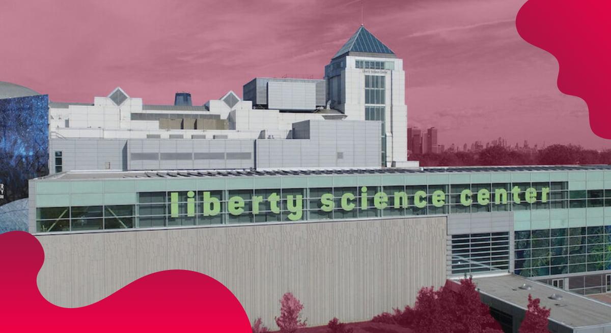 Liberty Science Center header image in red of a museum building.