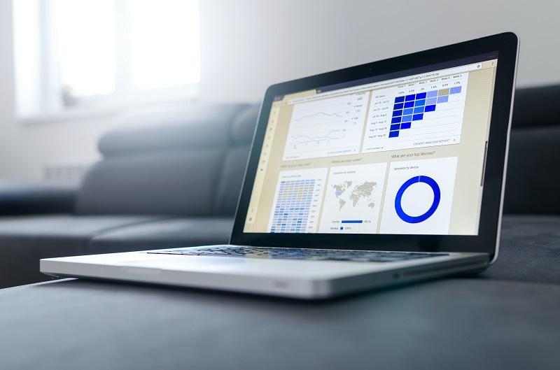 A laptop with multiple graphs on it.
