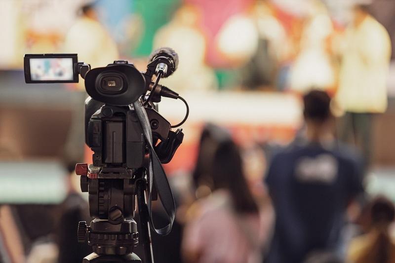 A camera pointing at an audience.