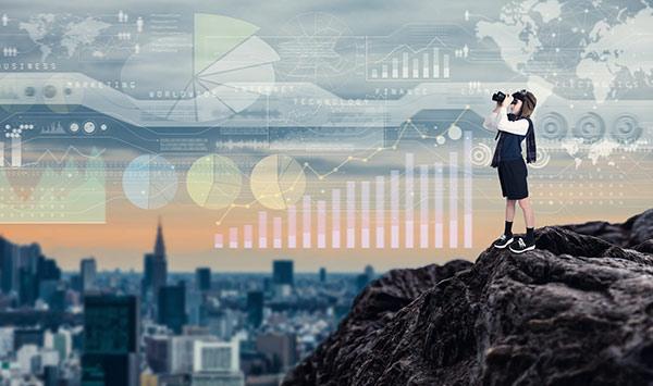 A child studying graphs using binoculars outdoors.