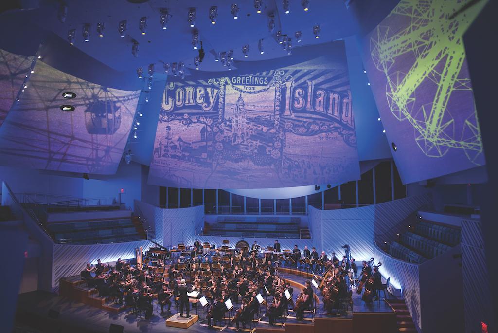 The NWS playing in a concert hall.