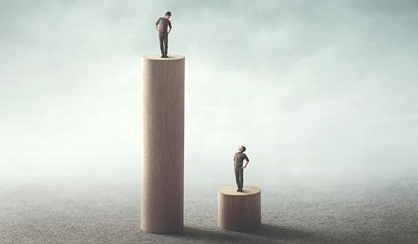 Two people on platforms of different height.