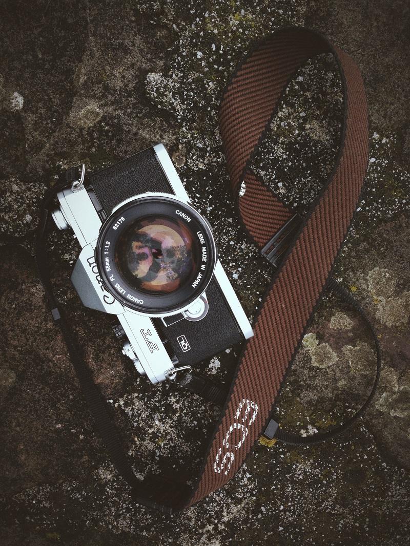 A Canon camera on rocks.