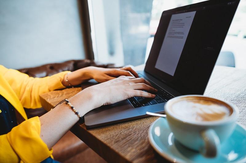 A young woman works on her laptop.