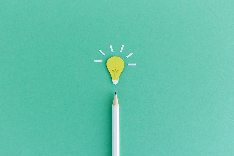 A pencil pointing to a light bulb.