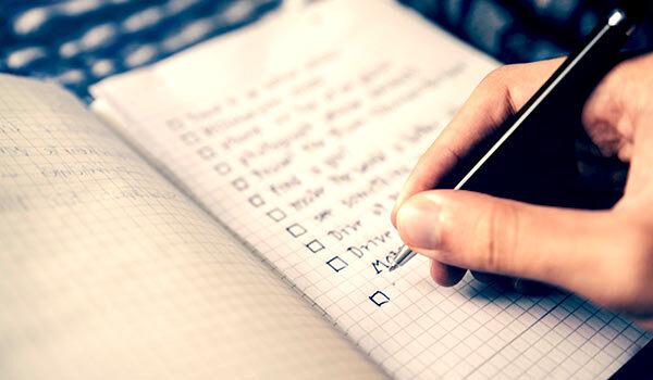 Someone making a list on paper.