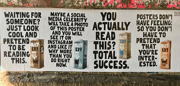 An Oatly poster outdoors.
