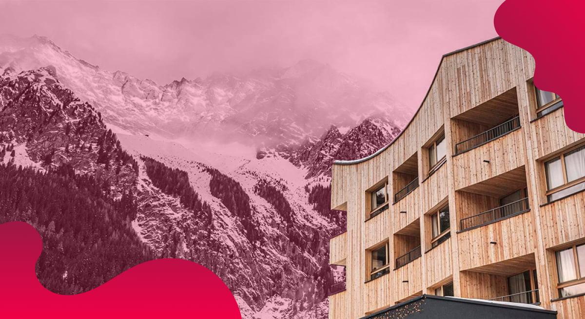 Das Titelbild der Falkensteiner Hotels in Rot zeigt ein Hotel am Fuße eines Berges.