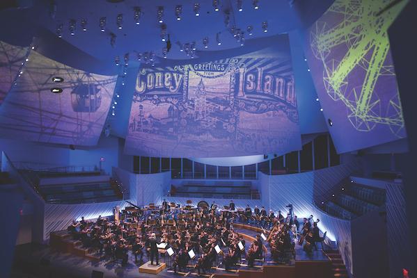 The NWS playing in a concert hall.