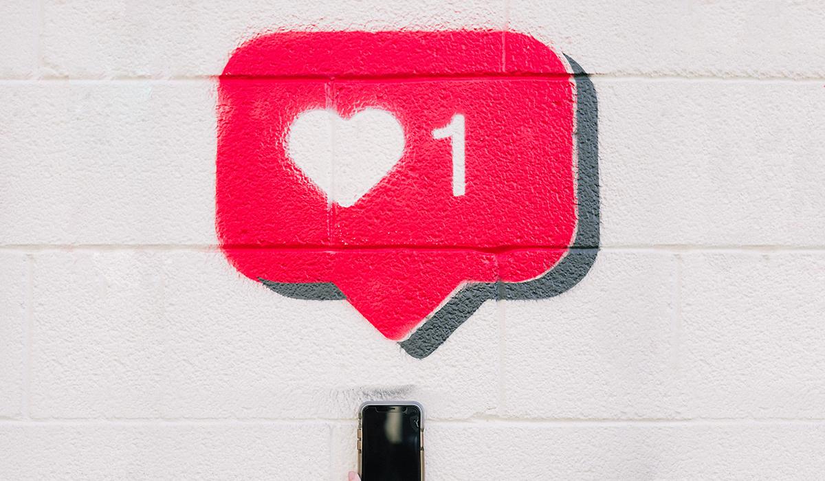 A heart popup over a smartphone.