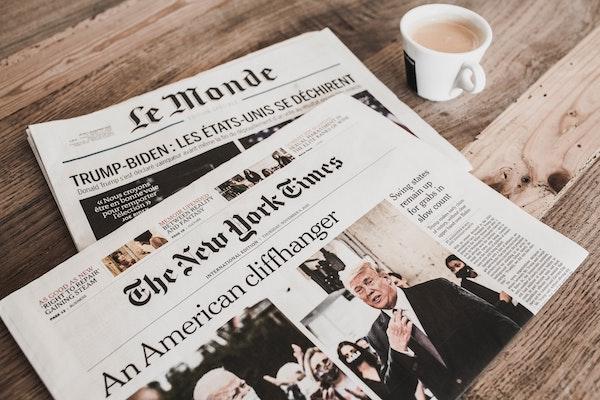 Front pages of New York Times and Le Monde print editions.