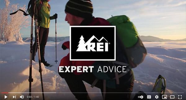Video still showing REI logo over a snowshoeing scene.