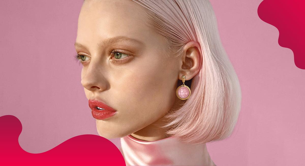 Lalique header image in red of model wearing luxury earrings.