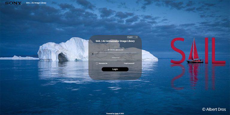 Sony's SAIL portal login screen, which has an iceberg in water with a blue sky and water, and a red sailboat cleverly in the water next to photoshopped letters S, I, and L surrounding it to make the word SAIL. In the center of the screen is the login box for inputting username and password to access the SAIL portal.