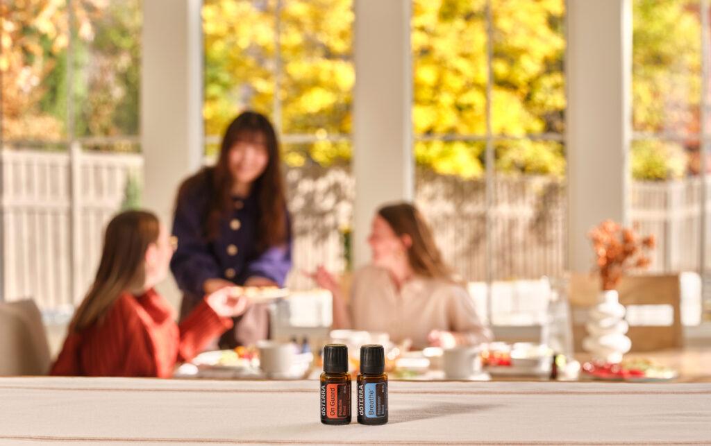doTERRA essential oils in the foreground while three women are talking in the background.