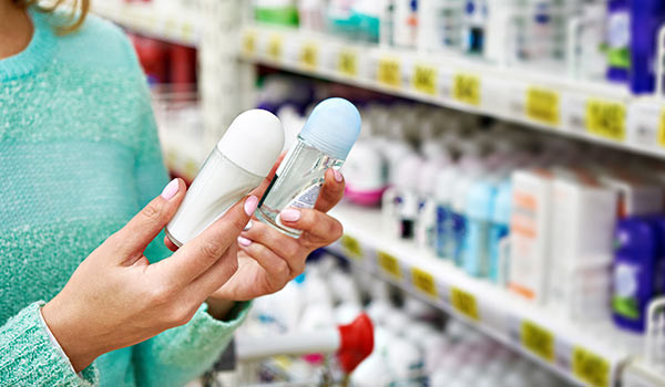 A person selecting between two different bottled products.
