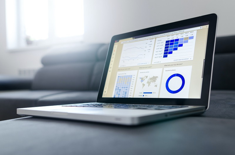 A laptop with multiple graphs on it.