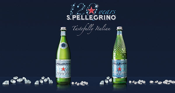 green San Pellegrino bottles with diamonds around with text that reads "120 years S. Pellegrino - Tastefully Italian" all over a navy blue background.