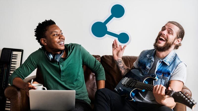 Two musicians with instruments laughing, one holds a symbol for sharing, the other has a laptop.